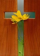 wooden cross with yellow flower