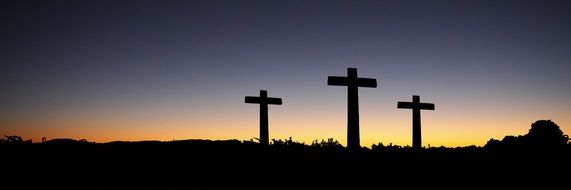 banner with a silhouette of crosses at sunset