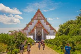 people in the square in front of a temple in thailand
