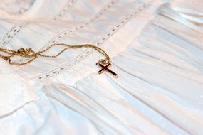 Gold Cross with Chain on white gown