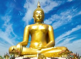 golden buddha statue against blue sky