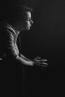 man prays in the dark