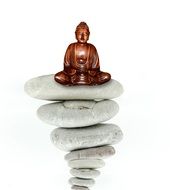 clipart of wooden buddha statue on stacked stones