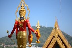 Beautiful and colorful statue in Thailand at background with the hill