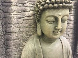 buddha statue near stone wall for meditation