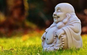 buddha like figure on green grass