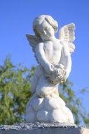 white sculpture of a cherub