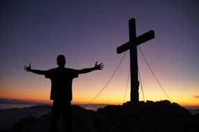 cross and man with open arms