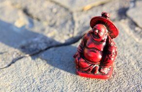 red buddha as a figure on a stone