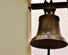 Close-up of the church bell on the wall