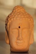 Ladybug on clay Buddha Head