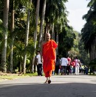 buddhist monk is walking down the street