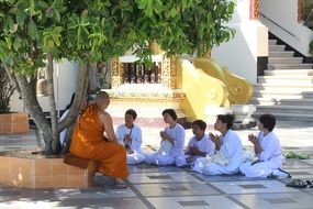 monks in yard at buddhist temple, thailand