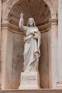 sculpture of jesus christ in the facade of the building