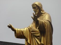 golden jesus statue near the wall