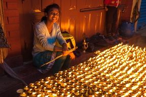 girl sitting near burning candles