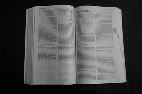 Bible book at black background