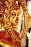 golden Buddha with expressive face in a temple in Bangkok