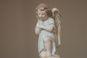 angel figurine on brown background