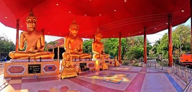 golden buddha statues beneath red shed at Temple, thailand, Bangkok, pathum wan