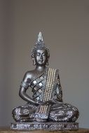 silver statue of a Buddha in Asia
