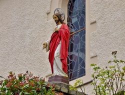 Christ statue against the background of a stained glass church