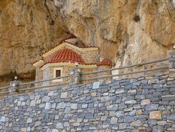 Church at Rock behind Stone wall, greece, crete