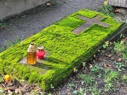 candles on a tomb in a cemetery, poland