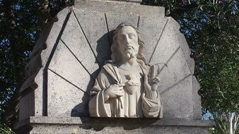 white bust of Jesus on a tombstone