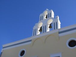 white church with bell tower on Santorini island