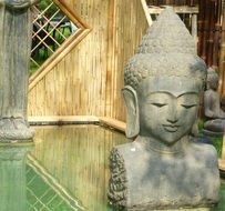 Buddha bust near the pond