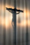 cross with a crucifix on the curtain