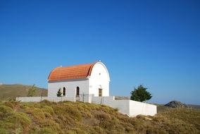 White Crete Church on a hill on a sunny day