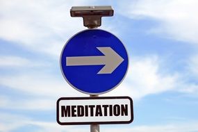 meditation pointer with arrow on blue sky background