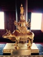golden statue on the altar in a buddhist temple in bangkok