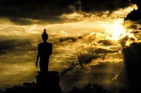 buddha statue silhouette in sunlight