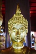golden buddha at the altar of a temple in bangkok