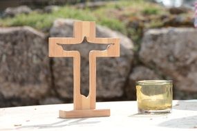 candle near the cross on the altar