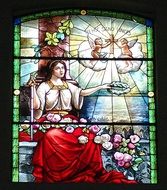 colorful illustration of a woman and angels on the church window