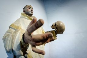 Skull on hand of catholic saint, sculpture