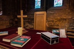 Cross and Prayer books on Altar in Church