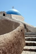 blue church dome under the bright sun in santorini