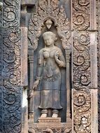 stone carved female figure on facade of Banteay Srei Temple, Cambodia