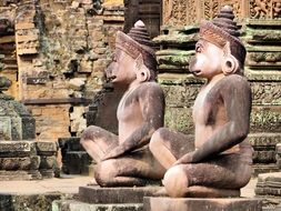 statues of monkeys near the destroyed temple