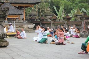 people pray near the temple in bali