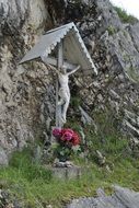 statue of crucifixion of Jesus near the stone wall