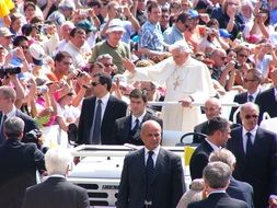 Pope stands on car in crowd, Italy, Rome