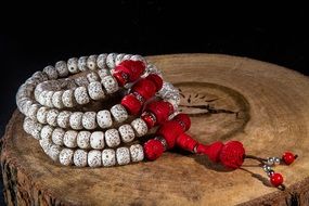Grey and red beads on the wood