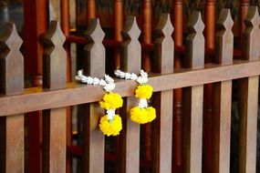 decorations with yellow flowers on a wooden fence