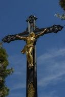 roadside cross with a golden crucifix